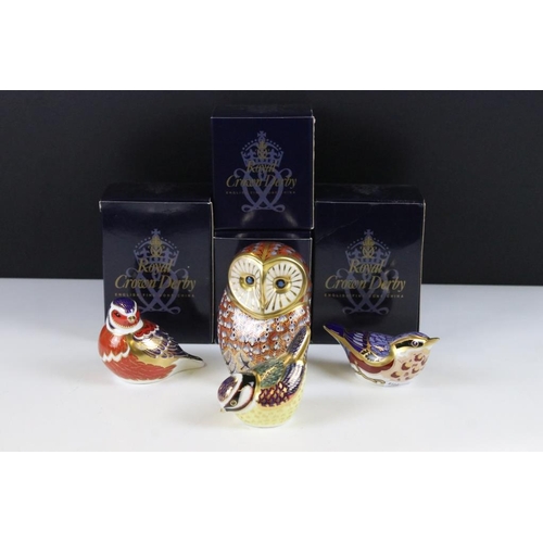 16 - Four Royal Crown Derby gold stopper paperweights to include a large owl, bluetit, chaffinch and nuth... 