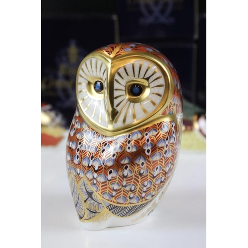 16 - Four Royal Crown Derby gold stopper paperweights to include a large owl, bluetit, chaffinch and nuth... 