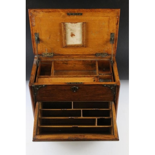 160 - Edwardian oak stationery cabinet, the raising of the lid causing the lower compartment to open, the ... 