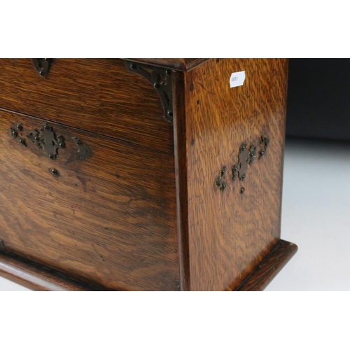 160 - Edwardian oak stationery cabinet, the raising of the lid causing the lower compartment to open, the ... 