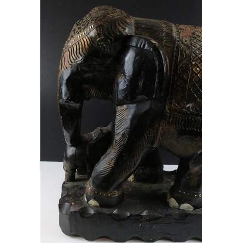 173 - Carved South East Asian hardwood figure group of an elephant and calf, with black painted finished, ... 