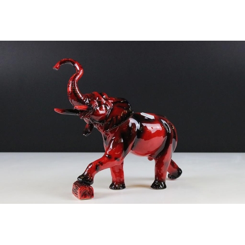 18 - Peggy Davies flambe elephant ceramic figurine, modelled with trunk raised. Printed marks to undersid... 