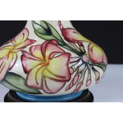 19 - Moorcroft ceramic lamp base in the frangipani pattern having tube lined yellow and pink flowers. Sti... 