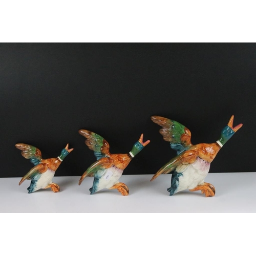 20 - Set of three Beswick ceramic flying duck wall plaques, each having hand painted details. Marked 596-... 