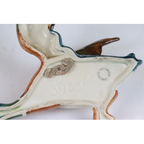 20 - Set of three Beswick ceramic flying duck wall plaques, each having hand painted details. Marked 596-... 