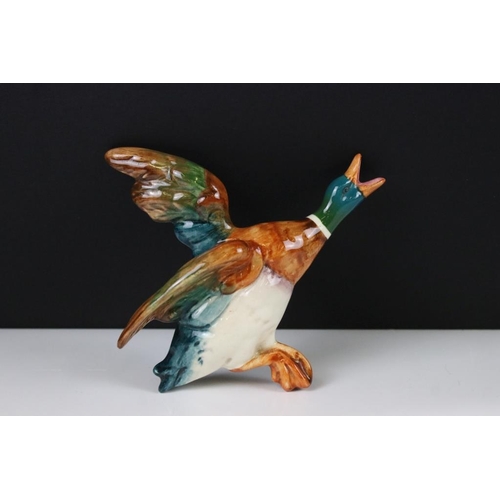 20 - Set of three Beswick ceramic flying duck wall plaques, each having hand painted details. Marked 596-... 