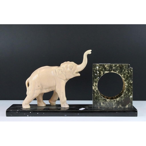 24 - Art Deco Ceramic Clock Holder, the slate base surmounted by an Elephant, 44cm long x 22cm high