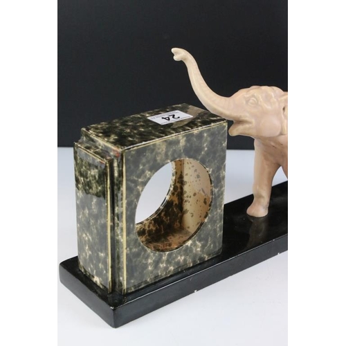 24 - Art Deco Ceramic Clock Holder, the slate base surmounted by an Elephant, 44cm long x 22cm high