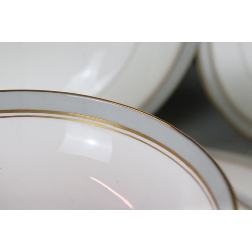 25 - Royal Worcester Howard pattern dinner service having grey and gilt rims. The lot to include two grav... 