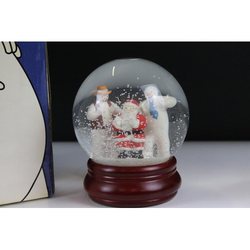 41 - Two Coalport 'The Snowman' snow globes to include 'At The Party' (no. 853 / 2000) and  Line Dancing.... 