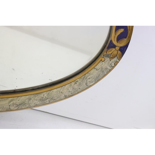 483 - Oval Bevelled edge Wall Mirror, the wooden framed partially painted with a swag of flowers on a blue... 