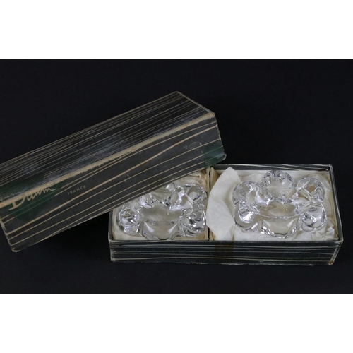 49 - Pair of Daum France glass table salts, both signed and in original box. Measures 6.5cm wide each.