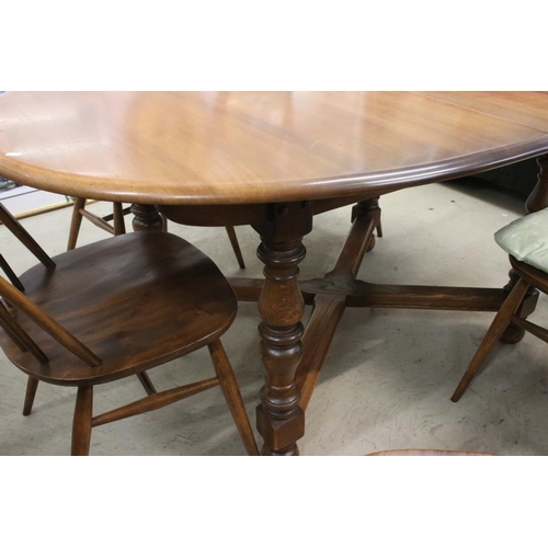 496 - Ercol Oval Extending Dining Table, 165cm long x 107cm wide x 75cm high together with a set of Six Er... 