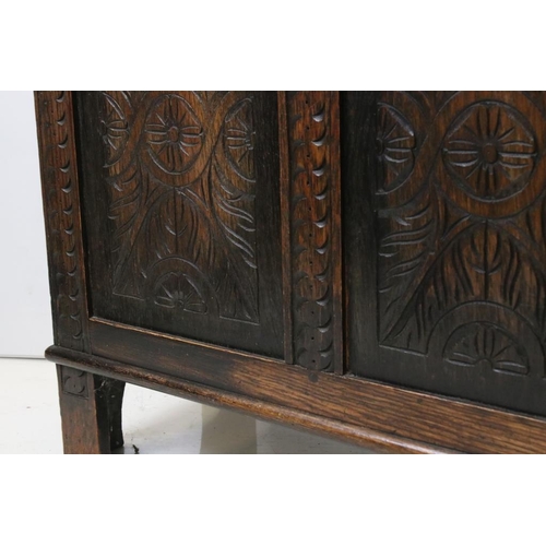 501 - Oak Coffer in the 17th century style with hinged lift lid and three carved panels to front, raised o... 