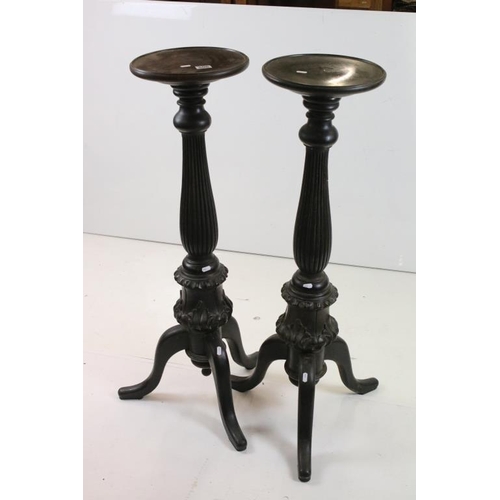 506 - Pair of 19th century Ebonised Jardiniere Stands, each with round tops over carved column supports an... 