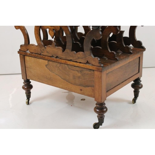 528 - Victorian Rosewood Canterbury having four carved pierced scrolling sections over a drawer, raised on... 