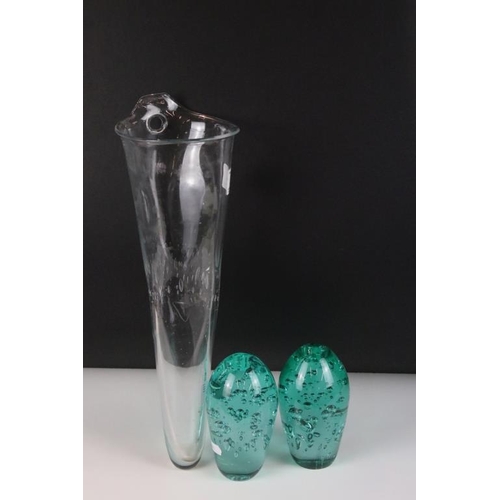 54 - Two control bubble end of day glass paperweights together with a clear art glass vessel with control... 