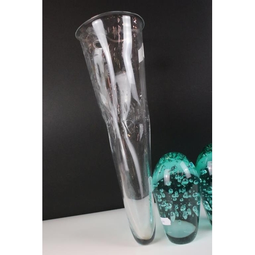 54 - Two control bubble end of day glass paperweights together with a clear art glass vessel with control... 