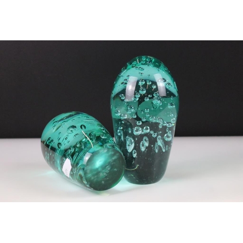 54 - Two control bubble end of day glass paperweights together with a clear art glass vessel with control... 