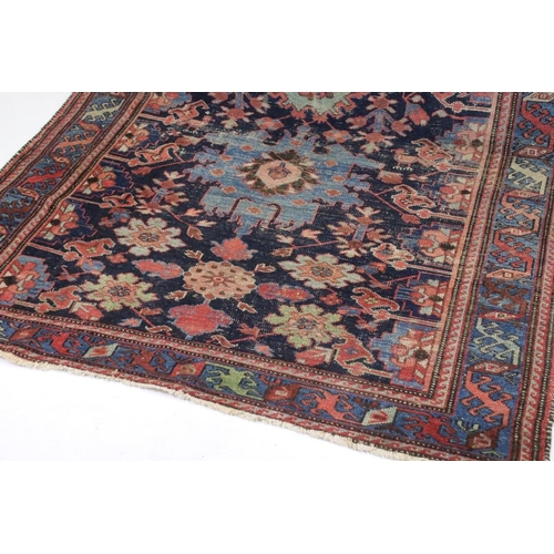 542 - Eastern Wool Blue ground Rug with stylised floral pattern within a border, 138cm x 192cm