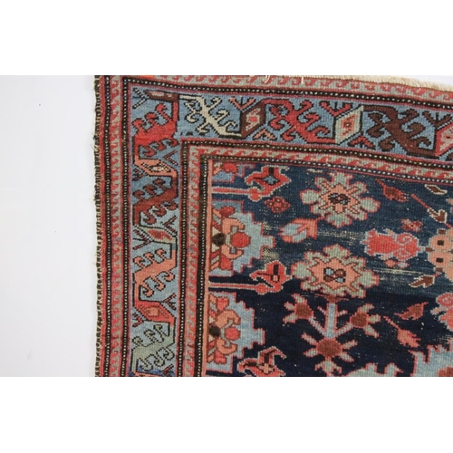 542 - Eastern Wool Blue ground Rug with stylised floral pattern within a border, 138cm x 192cm