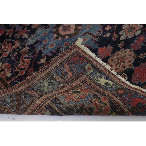 542 - Eastern Wool Blue ground Rug with stylised floral pattern within a border, 138cm x 192cm