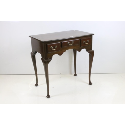 561 - George III style Mahogany Low Boy with three short drawers and shaped apron, raised on cabriole legs... 