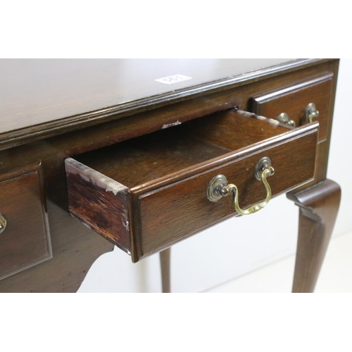 561 - George III style Mahogany Low Boy with three short drawers and shaped apron, raised on cabriole legs... 