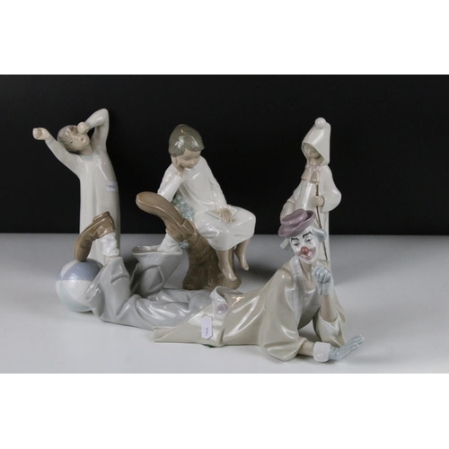 58 - Four Lladro figurines to include a large recumbent clown figure, yawning boy, reading boy and hooded... 