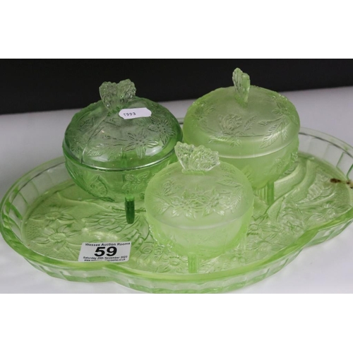 59 - Art Deco uranium green pressed glass dressing table set, together with a pressed glass vase. Vase me... 