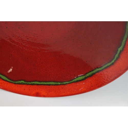 69 - Large Poole pottery red and glazed centrepiece bowl. Signed to verso. Measures approx 36cm diameter.