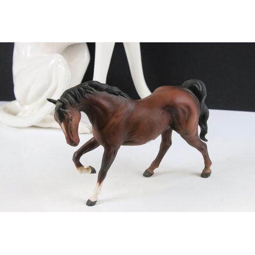 76 - Large ceramic figure of a seated Greyhound (50cm high), together with a Beswick matt brown horse mid... 