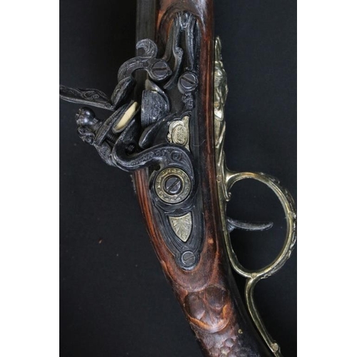 349 - Reproduction non firing French flint lock musket together with a reproduction sword and carved Afric... 