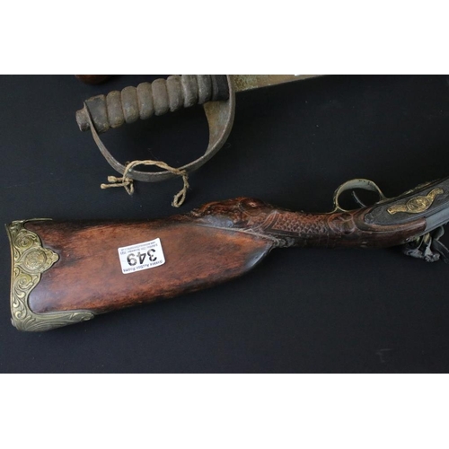 349 - Reproduction non firing French flint lock musket together with a reproduction sword and carved Afric... 