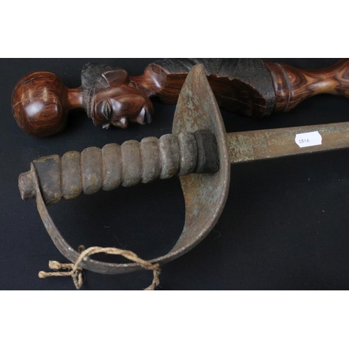 349 - Reproduction non firing French flint lock musket together with a reproduction sword and carved Afric... 