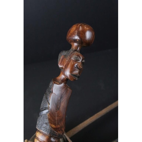 349 - Reproduction non firing French flint lock musket together with a reproduction sword and carved Afric... 