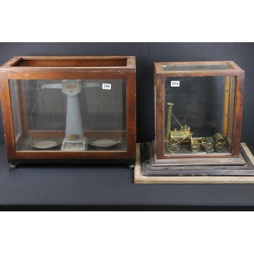 358 - Pair of Avery factory scales set within a wooden and glass case, together with a brass Stephenson's ... 