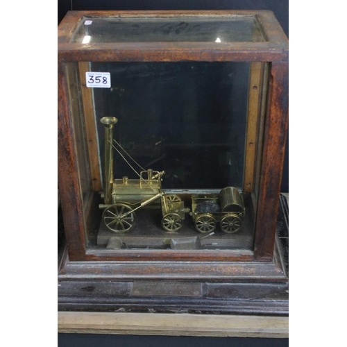 358 - Pair of Avery factory scales set within a wooden and glass case, together with a brass Stephenson's ... 