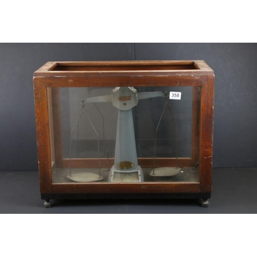 358 - Pair of Avery factory scales set within a wooden and glass case, together with a brass Stephenson's ... 