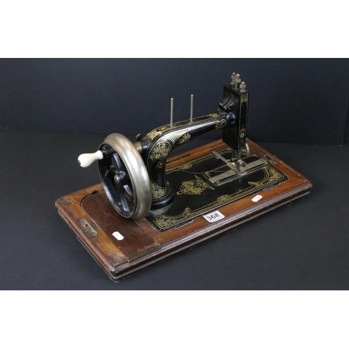 368 - German early 20th Century Dietrich sewing machine having a hand crank wheel with gilt floral detaili... 