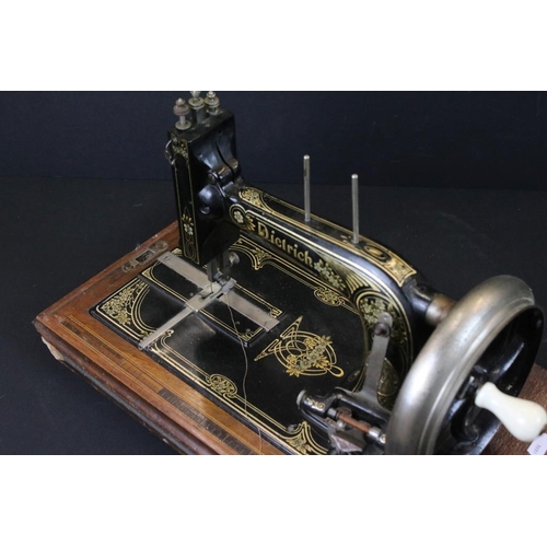 368 - German early 20th Century Dietrich sewing machine having a hand crank wheel with gilt floral detaili... 