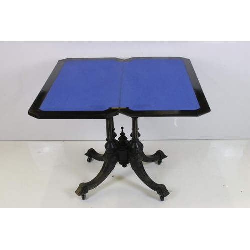 574 - Victorian Ebonised Fold-over Card Table, the hinged lid opening to a blue baise playing surface, rai... 