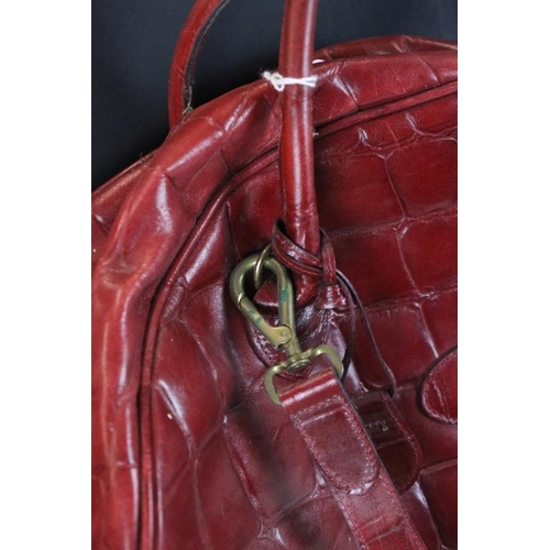 374 - Mulberry 'antique' leathers domed weekend holdall bag in maroon alligator embossed leather. The bag ... 