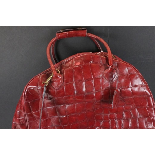 374 - Mulberry 'antique' leathers domed weekend holdall bag in maroon alligator embossed leather. The bag ... 