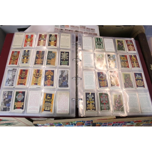 384 - Collection of stamps and cigarette cards across three boxes to include an album of definitives datin... 