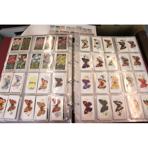 384 - Collection of stamps and cigarette cards across three boxes to include an album of definitives datin... 