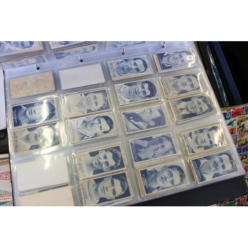 384 - Collection of stamps and cigarette cards across three boxes to include an album of definitives datin... 