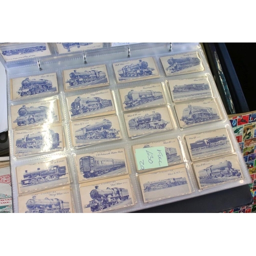 384 - Collection of stamps and cigarette cards across three boxes to include an album of definitives datin... 