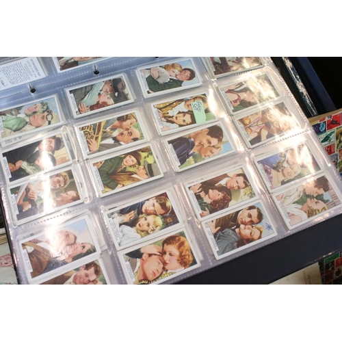 384 - Collection of stamps and cigarette cards across three boxes to include an album of definitives datin... 