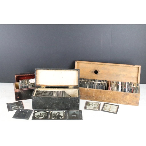 601 - A collection of over 100 magic lantern slides contained within three wooden boxes, mainly people to ... 